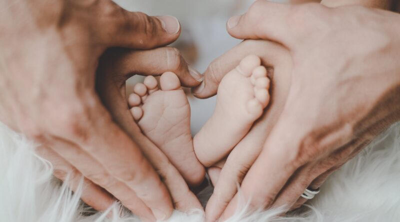 person holding baby s feet