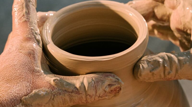 person making clay pot