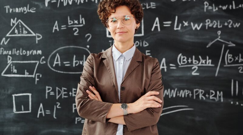 teacher standing in front of blackboard