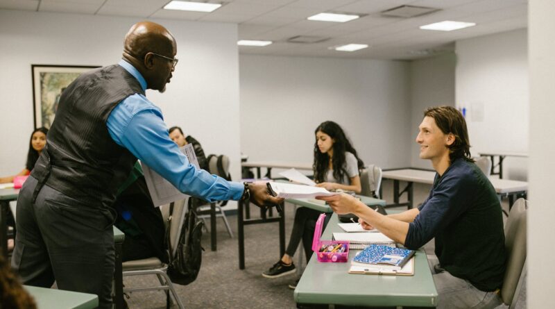 teacher giving the test result to his student