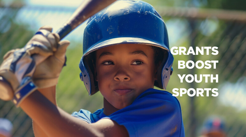 Close up of a young boy chalked up and ready to swing his bat in a little league game.