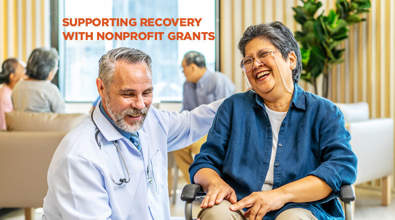 Older woman giggling while she receives assistance from her physical therapist.