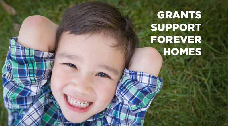 Laughing boy; son of o new homeowner helped by grants.