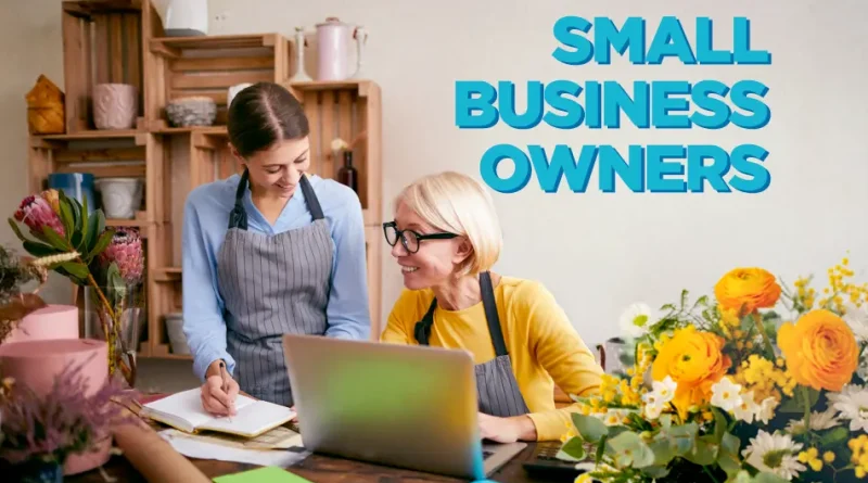 Business owner and employee sitting at a desk with flowers. The text reads Small Business Grants