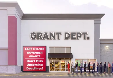 A line of people stands outside a large store-style building labeled “GRANT DEPT.” A red sign near the entrance reads “LAST CHANCE NOVEMBER GRANTS — Don’t Miss Upcoming Deadlines!” The image conveys urgency and demand for limited-time grant opportunities.