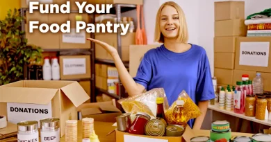 A smiling woman stands in a food pantry surrounded by shelves and boxes labeled “Donations.” She gestures toward several open boxes filled with canned goods, pasta, and pantry items. Bold white text on the image reads, “Fund Your Food Pantry.”