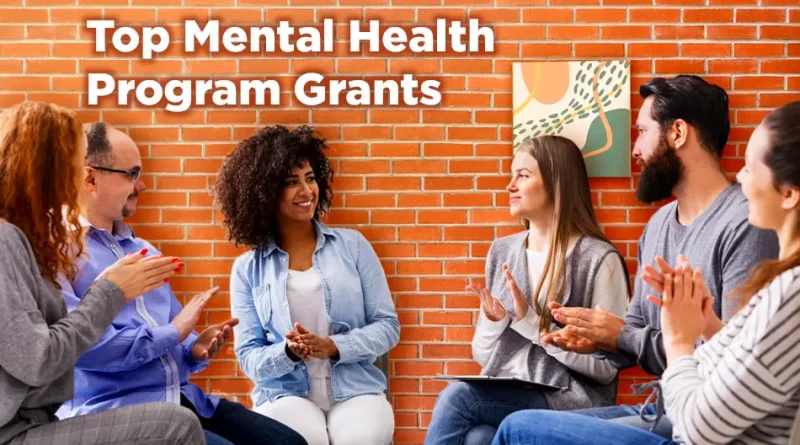 A diverse group of adults sits in a circle against a brick wall, smiling and applauding as they participate in a mental health support or group therapy session. The text “Top Mental Health Program Grants” appears at the top of the image.
