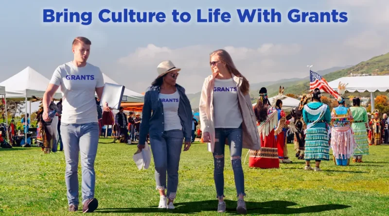 Three people wearing “GRANTS” shirts walk through an outdoor cultural festival, with tents, traditional dancers in colorful regalia, and an American flag in the background under the headline “Bring Culture to Life With Grants.”