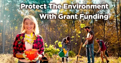 Volunteers plant young trees in a forest during autumn, with a smiling woman holding a sapling in the foreground and the text “Protect The Environment With Grant Funding” displayed above.