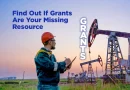 Worker in safety gear reviews notes at an oil field with pumpjacks at sunset, alongside text reading “Find Out If Grants Are Your Missing Resource” and “Grants.”
