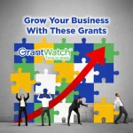 At the top, there’s a bold headline: “Grow Your Business With These Grants.” In the center, a colorful puzzle made of blue, green, yellow, and white pieces forms a backdrop. Over the puzzle is the logo “GrantWatch – Time to Apply.”