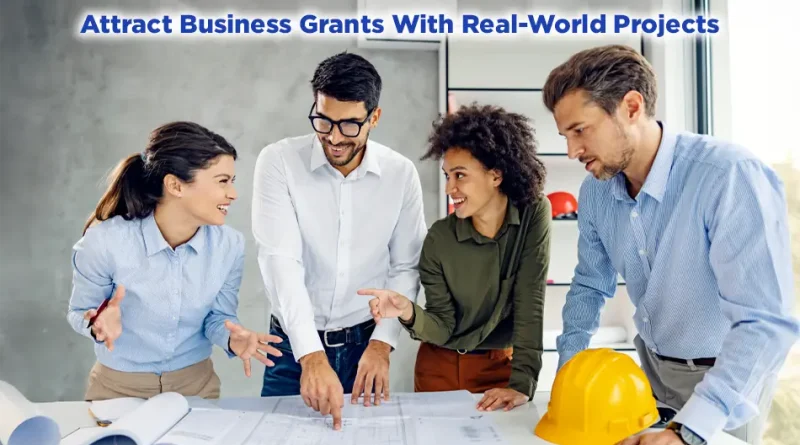 Four business professionals collaborate over blueprints on a table, smiling and pointing at plans. A yellow construction hard hat sits nearby. Text on the image reads: “Attract Business Grants With Real-World Projects.”