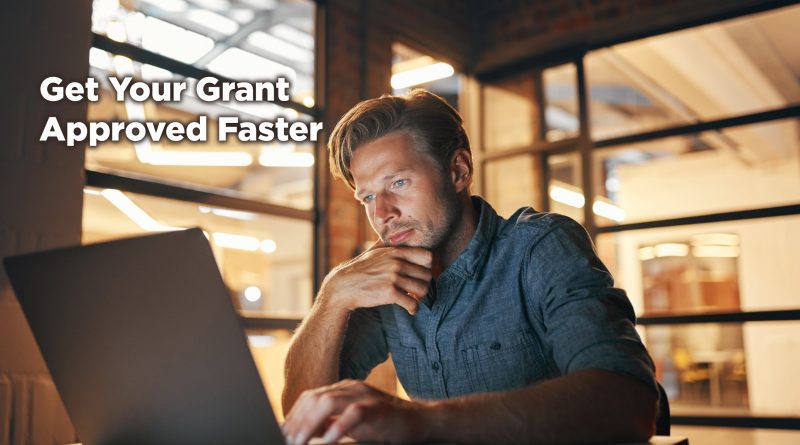 Man working late at a laptop in a warmly lit office, focused and thoughtful, with overlay text reading “Get Your Grant Approved Faster.”