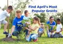 Spring time view of a community planting project, the scene shows volunteers teaching children how to plant and nurture growing things.