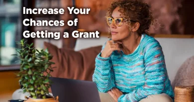 A woman sits on a comfortable couch. She is grinning and seems to exude confidence and surety. The caption reads: Increase Your Chances of Winning a Grant.