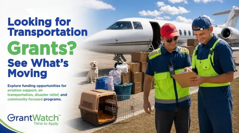 A GrantWatch promotional graphic featuring two transportation workers reviewing a clipboard beside a private jet and stacked cargo boxes on an airport runway. A dog sits near pet carriers and supplies in the background. The text reads, “Looking for Transportation Grants? See What’s Moving,” and highlights funding opportunities for aviation support, air transportation, disaster relief, and community-focused programs. The GrantWatch logo appears in the bottom left corner.