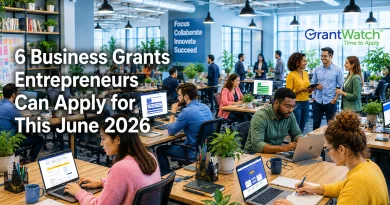 6 Small Business Grants Entrepreneurs Can Apply for This June A busy modern office filled with entrepreneurs and professionals working at desks, collaborating in small groups, and using laptops in a bright, open workspace with plants throughout. Large text on the left reads, “6 Business Grants Entrepreneurs Can Apply for This June 2026.” A GrantWatch logo appears in the upper right corner. The office atmosphere conveys innovation, teamwork, and business growth, with a wall sign in the background displaying the words “Focus, Collaborate, Innovate, Succeed.”