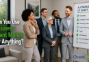 A diverse group of business professionals stands in a modern office conference room beside a presentation board titled “Allowable Uses of Grant Funds.” The board lists potential grant-funded expenses, including equipment and employee training as approved uses, while marketing, salaries, travel, entertainment, personal expenses, and luxury purchases are marked with questions or restrictions. Large text on the image asks, “Can You Use Business Grant Money for Anything?” The GrantWatch logo appears in the bottom right corner.