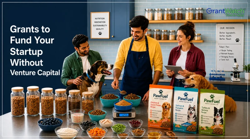Three people in a pet food startup kitchen and testing lab prepare dog food recipes while interacting with two dogs. Shelves of ingredients, measuring tools, bowls of food, and packaged pet food products are displayed on a worktable. Large text on the left reads, “Grants to Fund Your Startup Without Venture Capital,” with the GrantWatch logo in the upper-right corner.