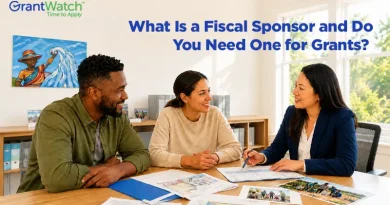 Three professionals meeting at a table to discuss grant funding and nonprofit project planning, illustrating fiscal sponsorship and grant eligibility for organizations seeking funding opportunities.