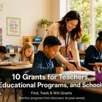Teacher helping students work at desks in a bright elementary classroom, with educational posters on the walls and text promoting grants for teachers, educational programs, and schools.