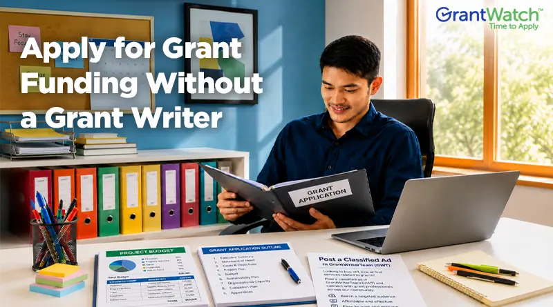 A person sits at a desk reviewing a grant application folder in a bright office. A laptop, project budget documents, grant application outline, office supplies, and colorful filing binders are arranged around the workspace. Large text reads, "Apply for Grant Funding Without a Grant Writer," with the GrantWatch logo displayed in the upper-right corner. The image conveys independent grant seeking, organization, and grant application preparation.