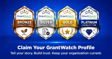 Graphic with a blue gradient background displaying four GrantWatch visibility tier badges: Bronze with a sprout icon, Silver with a checklist icon, Gold with a star and laurel icon, and Platinum with a diamond icon. Large white text reads, "Claim Your GrantWatch Profile," followed by the message, "Tell your story. Build trust. Keep your organization current."