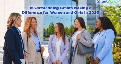 15 Outstanding Grants Making a Difference for Women and Girls in 2026 Four professionally dressed women stand outdoors in front of a modern office building, smiling and talking. Overlay text reads, "15 Outstanding Grants Making a Difference for Women and Girls in 2026," with the GrantWatch logo in the upper-right corner.